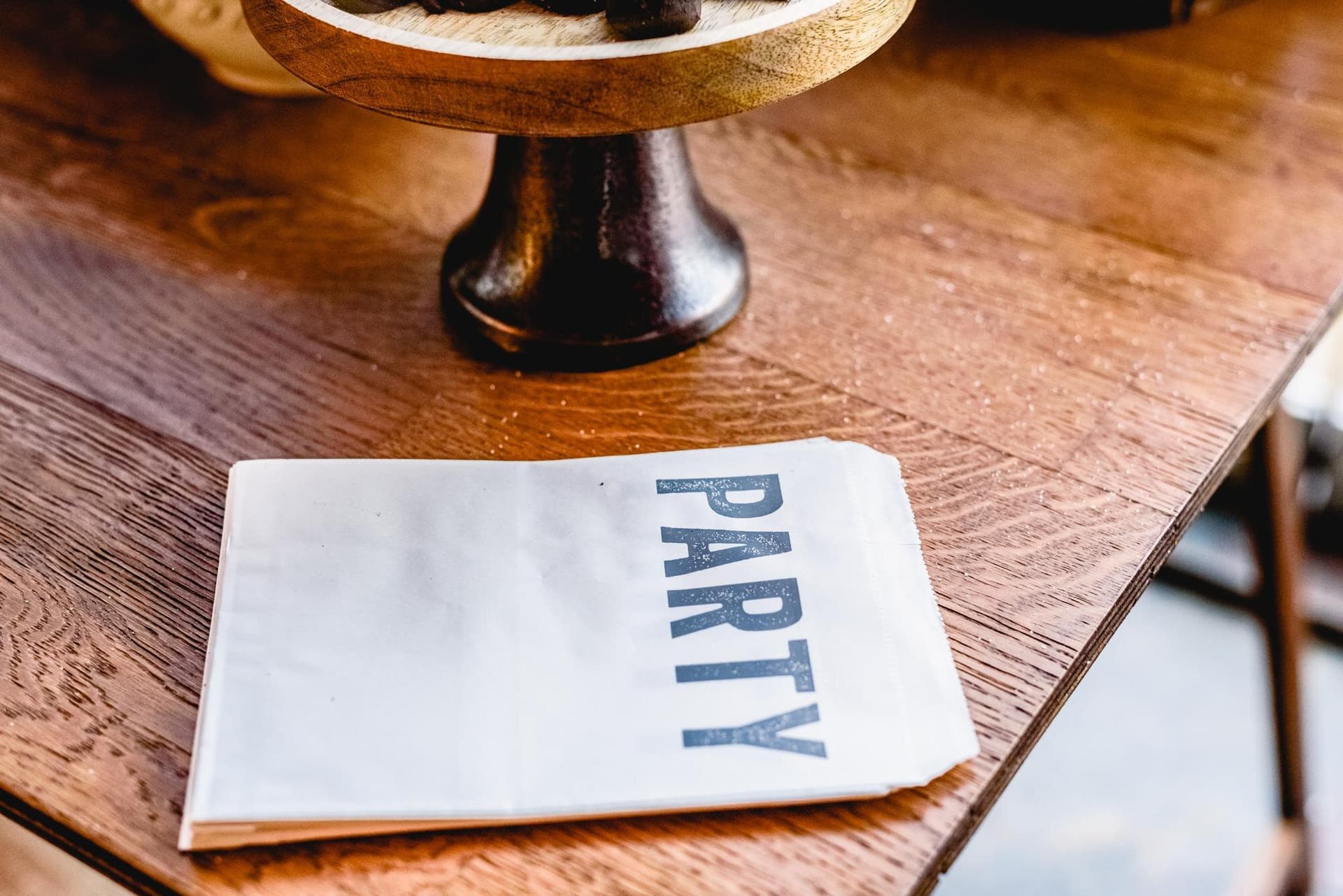 Printed restaurant menu on a wooden table — the kind of menu still trapped in PDFs online